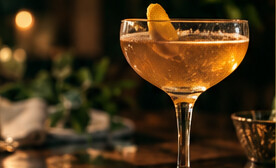 An imagined amber cocktail glass in warm evening light.