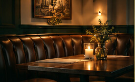 An imagined leather dining booth softly lit by candlelight.
